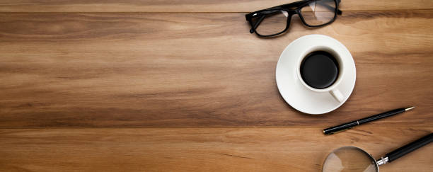 istock magnifier with glasses and coffee 1296834384