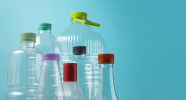 Varieties of Used Plastic Bottles Isolated on blue background. Reuse, Recycle and Zero Waste Campaign