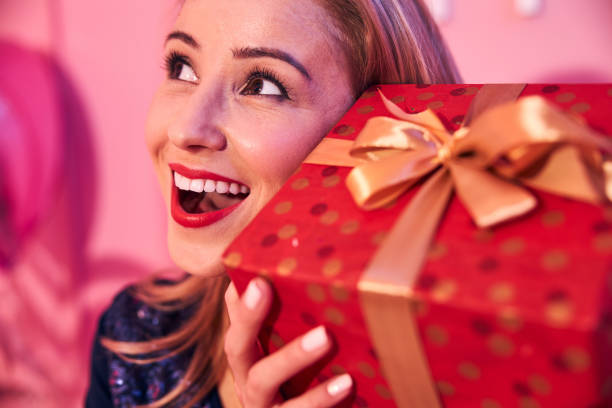 istock Pleased female with a gift box looking up 1296839316
