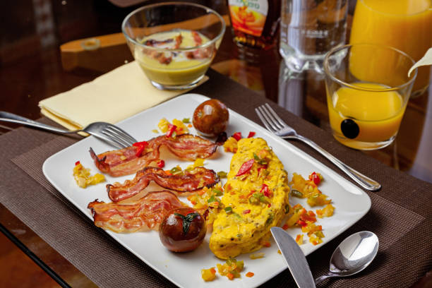 istock Omelette with fried bacon, black tomatoes, sauted vegetables and pea soup 1296839960