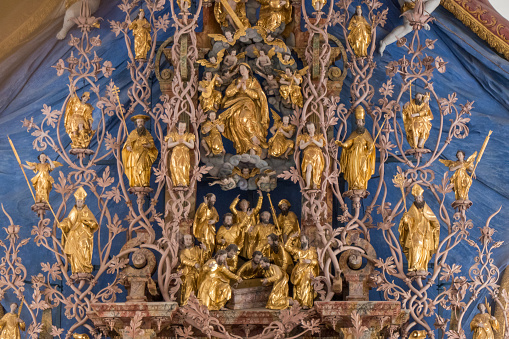 One of Tirol’s true architectural gems is the splendid Cistercian Abbey of Stams, founded in 1273. The photo shows the interior of the baroque collegiate church. The altar screen is overgrown with thick tendrils, a “Tree of Life”, springing from the base of the altar with the figures of Adam and Eve ascends via the central figure of the salvational “Immaculata” to the crucifixion as a symbol of redemption.