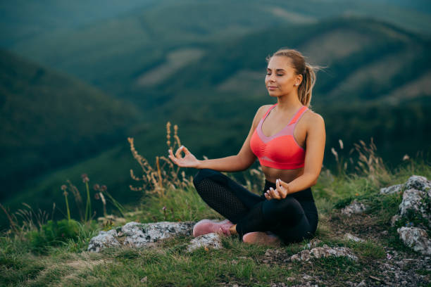 istock Young woman practicing yoga in nature 1296844378