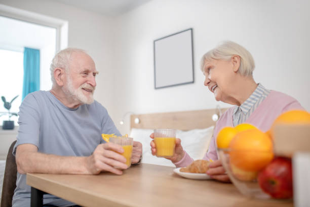 istock Senior couple having breakfast and looking peaceful 1296844917