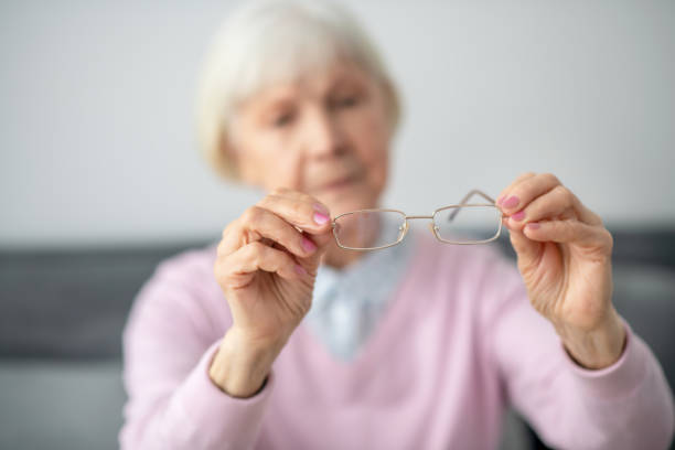 istock Senior woman holding eyeglasses in her hands 1296844966
