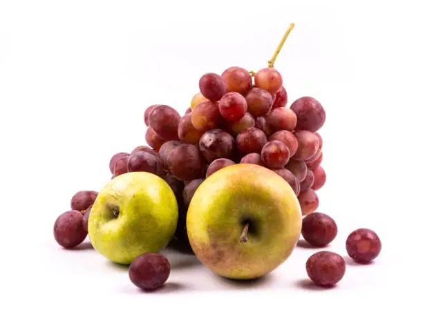 Photo of Bunch of grapes and apples on white background