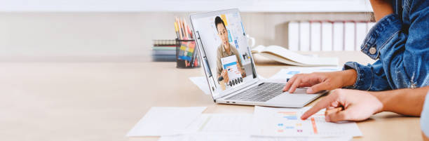 istock New normal office lifestyle.asian creative designer video conference collaboration with colleagues.live streaming meeting.banner mockup for display of content 1296851589