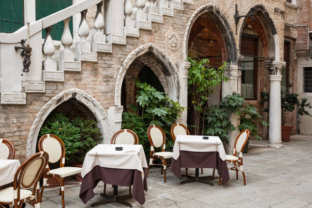 istock Tables waiting for guests outside a restaurant, Venice, Italy 1296851702