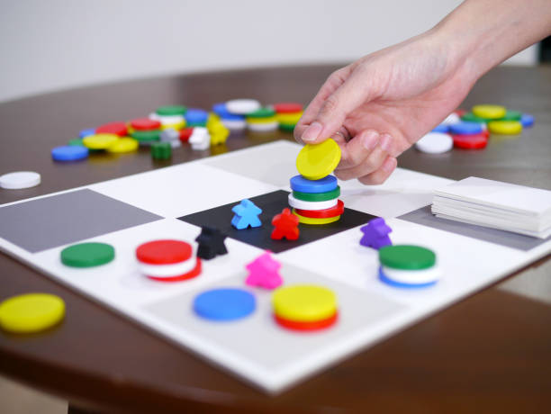 istock people playing fun board game on wooden table top selected focus 1296853255