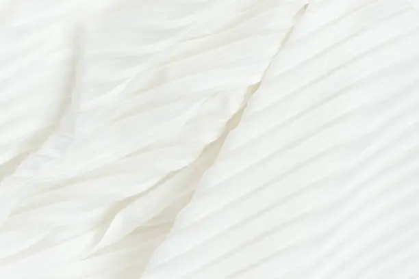 Photo of Background of white pleated fabric located diagonally