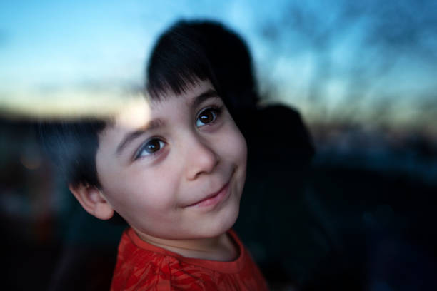 istock child looking out the window 1296856077
