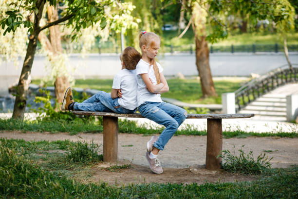 istock Children resent each other on a bench. 1296856495