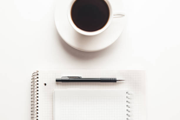 istock Office desk table with supplies, coffee cup and flower. Top view 1296858743