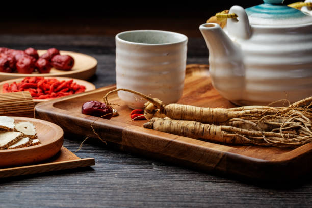 istock Ginseng and tea cup are on the table 1296859671