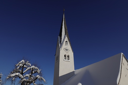 Gnadenwald, Austria - January 16, 2021: Church St. Michael in Gnadenwald after heavy snowfall.