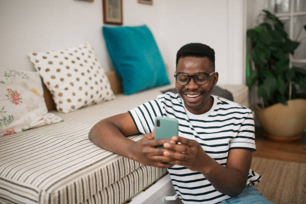 istock Happy young African American man using a smart phone 1296862079