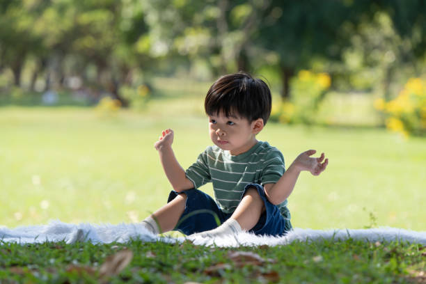 istock Asian little child having fun playing in the park 1296862148