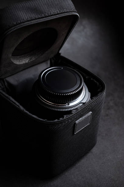 lens for SLR camera in opened case for transport on dark background
