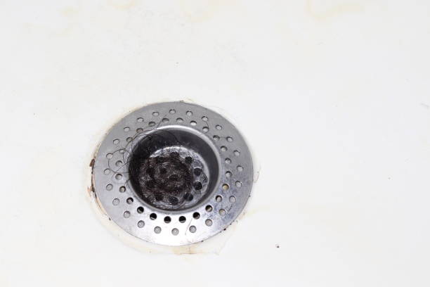 istock Hair stuck in sink or bath drain. 1296862570