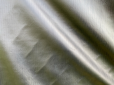 black waterproof tarp fabric hanging with natural folds with shadows