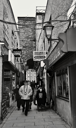 People walk through the narrow Merchant's Arch Alley, Dublin, Ireland, B&W taken  in January 2010