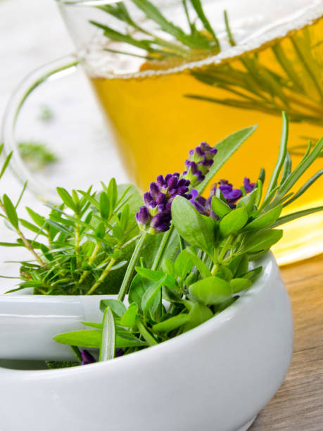 istock Herbal tea and fresh leaves with mortar 1296866107