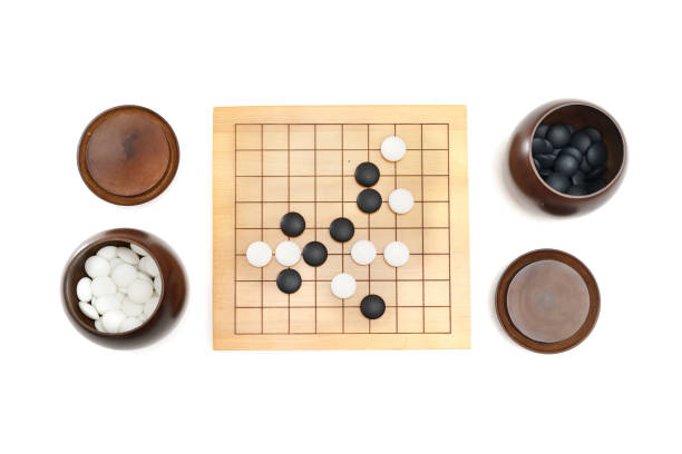istock Go game stones in wooden bowls 1296866171