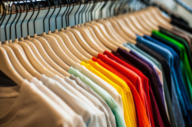 istock Different T-shirt colors hanging in a row 1296866219