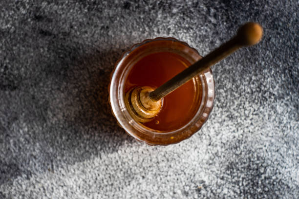 istock Organic honey in glass jar 1296871271