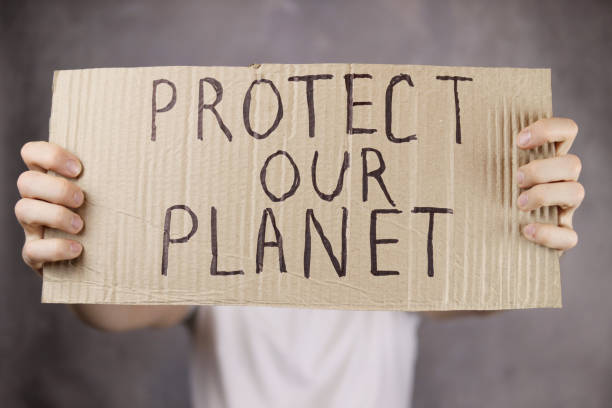 istock hands holding a cardboard poster with an inscription save our planet 1296872332