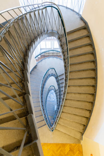 istock Top down view to oval narrow spiral staircase 1296873993