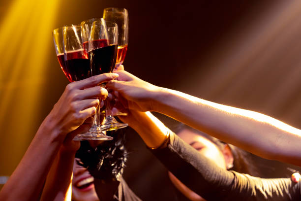 Group of people toast drinks at party in dancing club