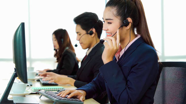 istock Business people wearing headset working in office 1296877018