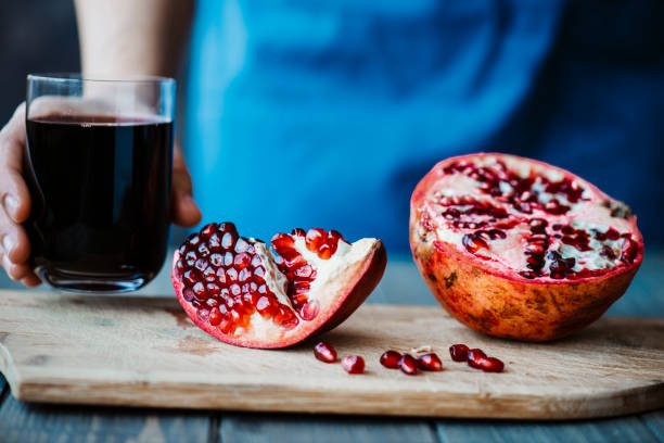 istock Woman Holding Pomegranate Juice 1296877055