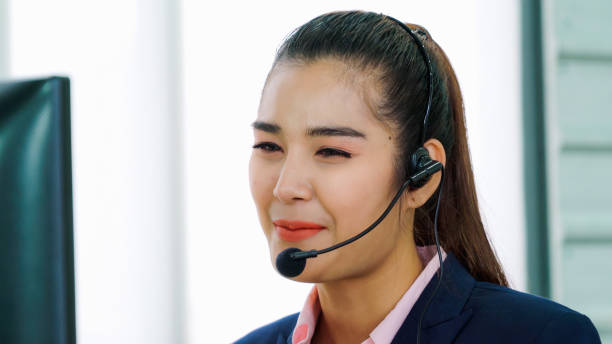 istock Business people wearing headset working in office 1296878059