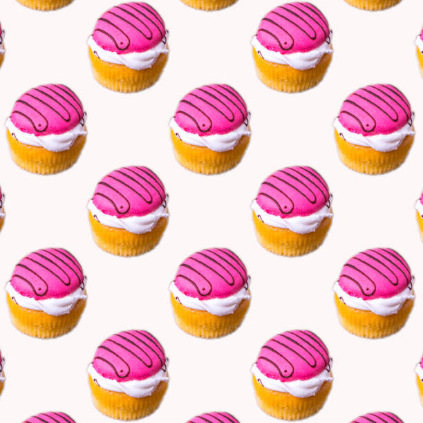 istock Cupcakes with white and pink cream on a white background, flat layout, seamless pattern, wallpaper, banner, template 1296878501