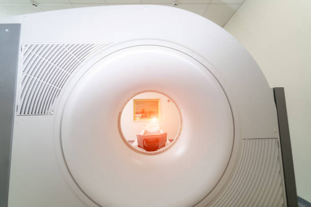 istock CT Scanner. Computed tomography isolated. Scan room background. Oblique view. Medical technology concept. Clipping path. 1296880264