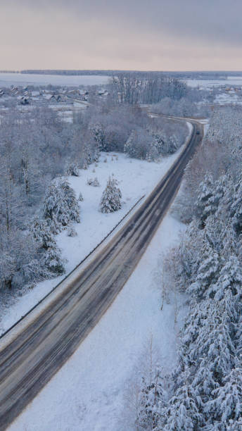 istock snowy forest road a lot of coniferous trees drone view 1296882113