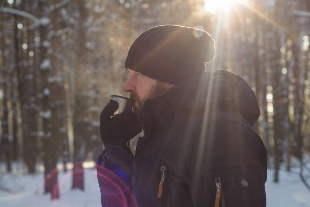 istock A frozen man  in winter sunny forest 1296882329