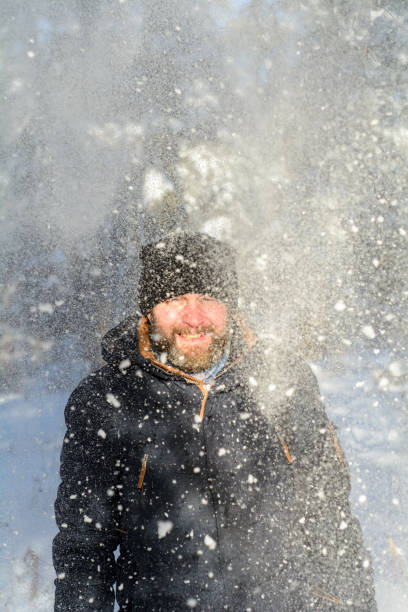 istock A frozen man  in winter sunny forest 1296882958