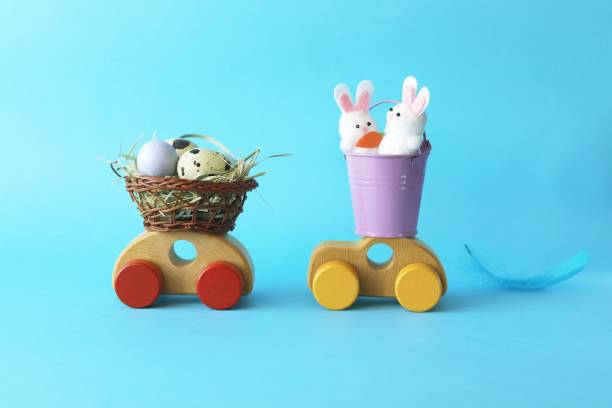 istock Easter eggs in a basket, decorations on a toy car, congratulations, postcard 1296883420