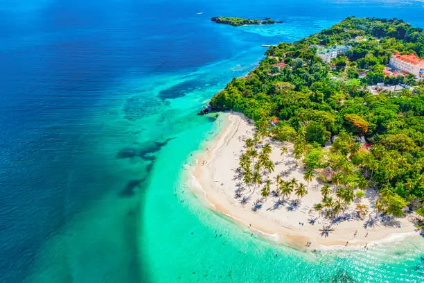 Aerial drone view of the beautiful small island and palm trees of Atlantic Ocean. Cayo Levantado island, Samana, Dominican Republic.