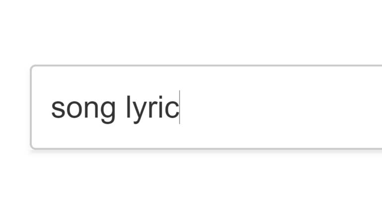 Searching For Song Lyrics in Search Bar Screen View. Online Network Website Search Box. Searching The World Wide Web Internet on a Computer. Typing Into Search Engine Box Viewpoint of Monitor Screen Close-Up. Music Words.