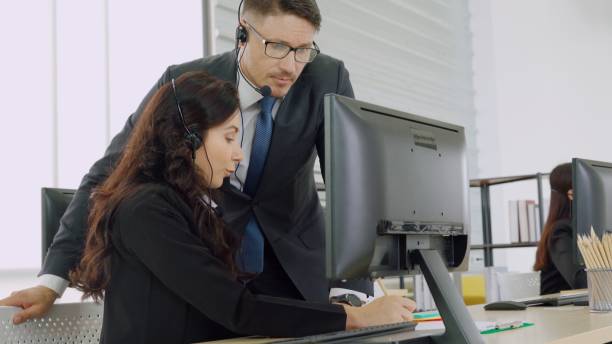 istock Business people wearing headset working in office 1296888038