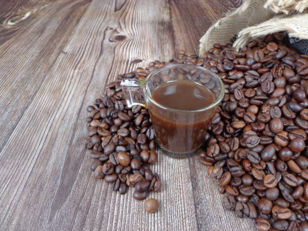 istock Cup of coffee surrounded by roasted coffee beans 1296889786