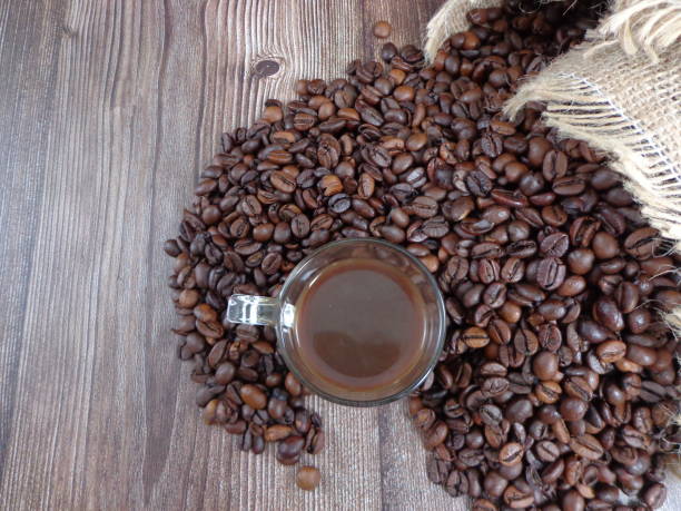 istock Cup of coffee surrounded by roasted coffee beans 1296889847