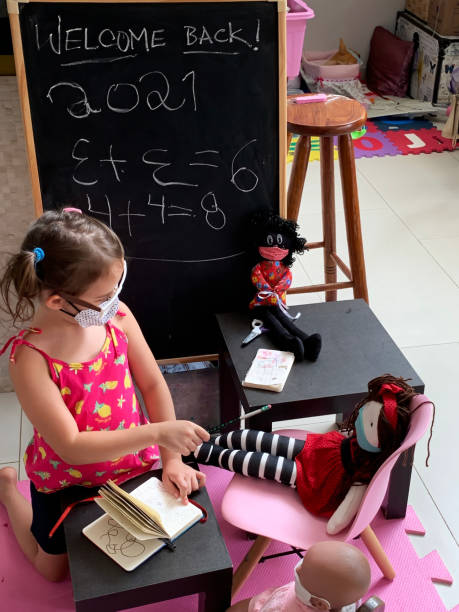 istock Little girl playing teacher. 1296892493