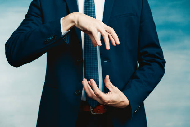 Hands of a man in a blue jacket folded in the shape of a sphere or as if pulling something Hands of a man in a blue jacket folded in the shape of a sphere or as if pulling something. male is standing and shows outstretched hand with open palm stock pictures, royalty-free photos & images