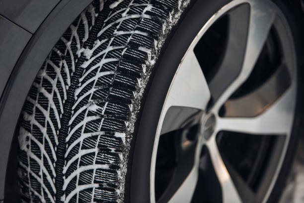 istock Car tires on winter road covered with snow 1296894034