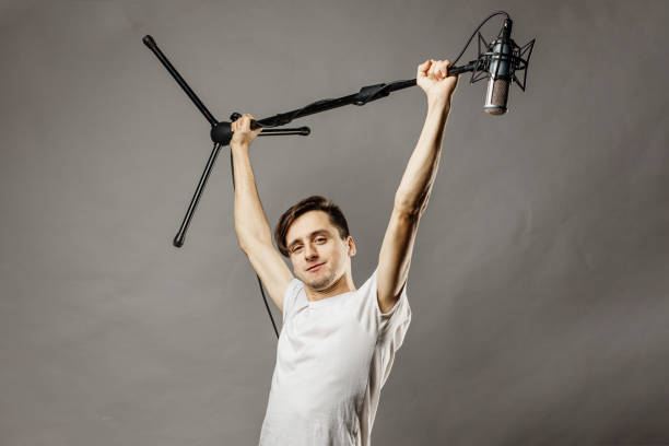 istock Caucasian man holding a microphone. Studio shout 1296894913