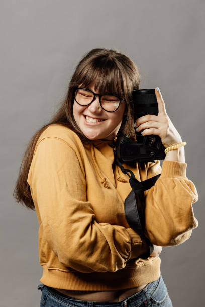 istock Young woman holds a camera in her hands 1296894991
